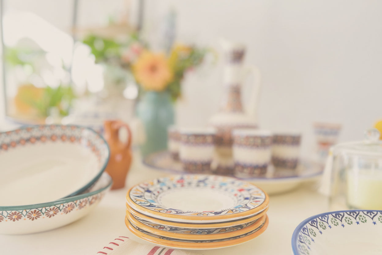 Colorful ceramic plates on a table with a blurred background